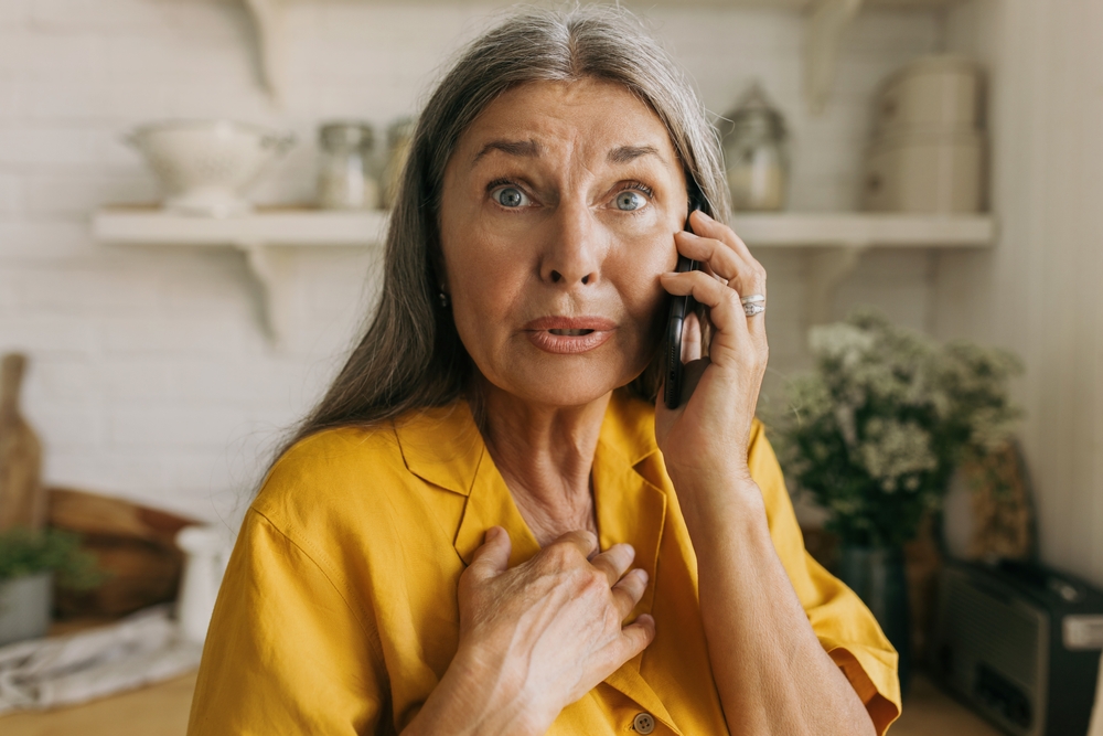 Shocked senior woman hear bad news on mobile phone. Surprised or astonished facial expression, talk to family or friend. Communication, chatting, emotion, fear, technology concept