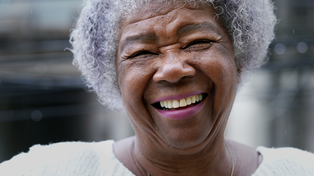 A joyful older black woman authentic smile real happy expression