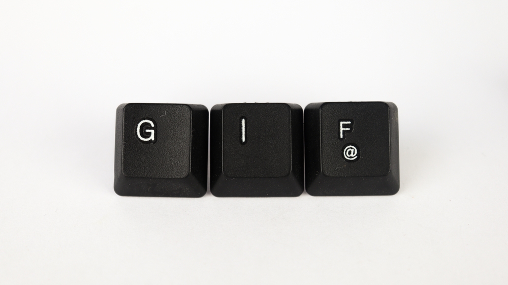 GIF text created with keyboard keys isolated on white background, design terminology, white GIF on black keyboard, top view