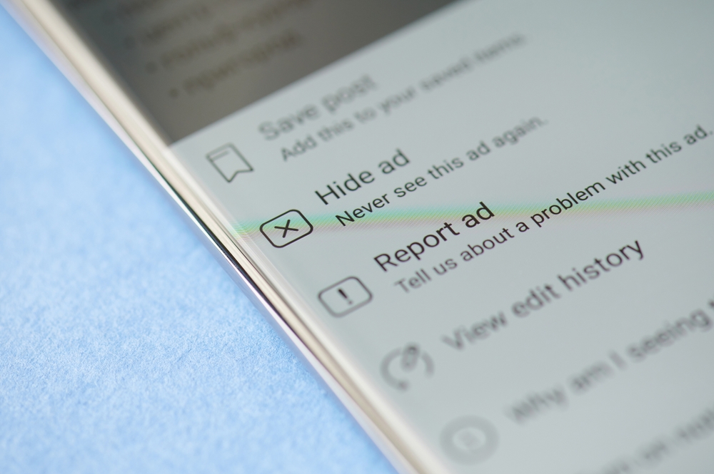 New york, USA - June 28 2021: Never see ad again button in facebook on smartphone screen close up