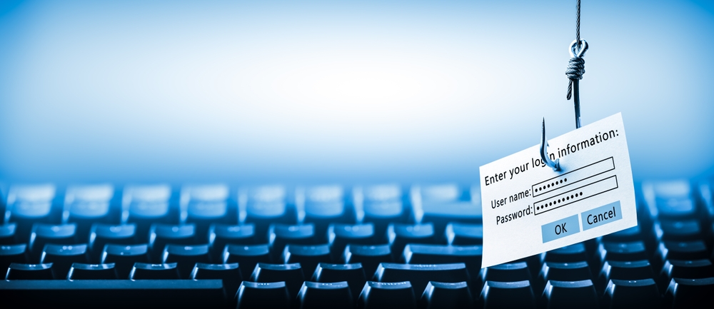 Login Information Attached To Large Hook Hanging In Front Of Computer - Cyber Crime - Phishing Concept