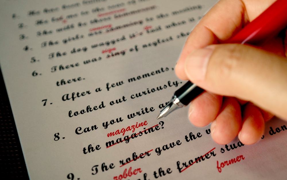 spelling check paperwork with red mark error correction