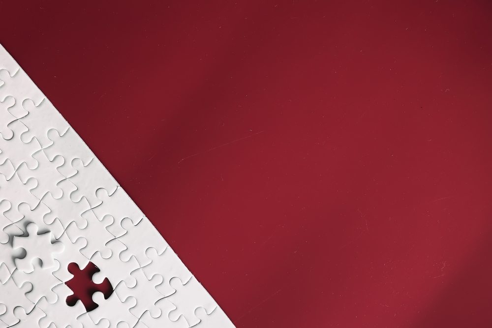 Clean puzzle elements on the background. Empty puzzle piece on table. Teamwork concept.