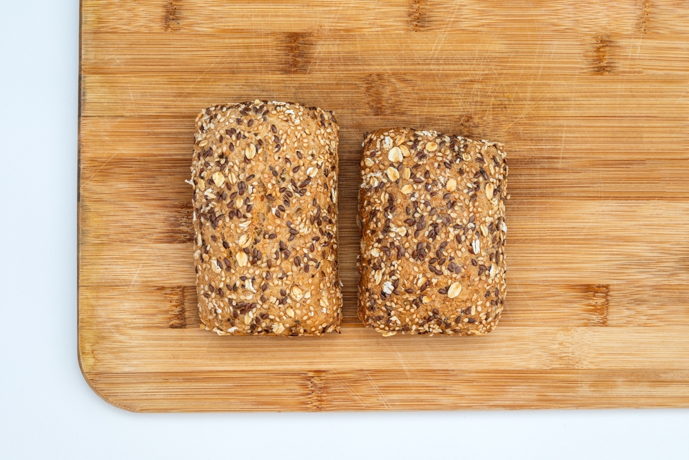 Downsized bread roll sales comparison. Food Inflation, skimpflation vs shrinkflation concept of less for the same price. Inflation cost living concept.