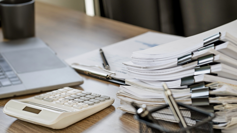 stack of paperwork with unfinished documents achieves
