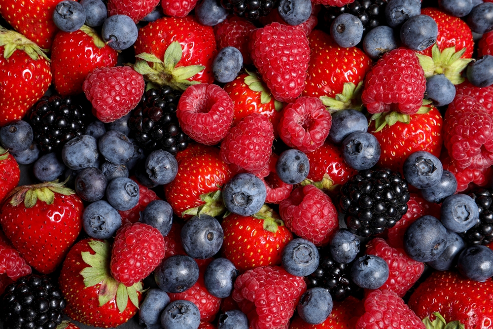 Assortment of fresh ripe berries as background, top view