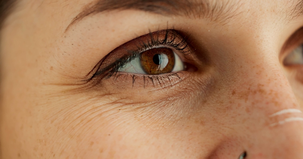 Eyes, thinking and future with person closeup in studio for hope, optimism or contemplation. Eye health, vision and planning with model looking away for natural cosmetics, optometry or satisfaction