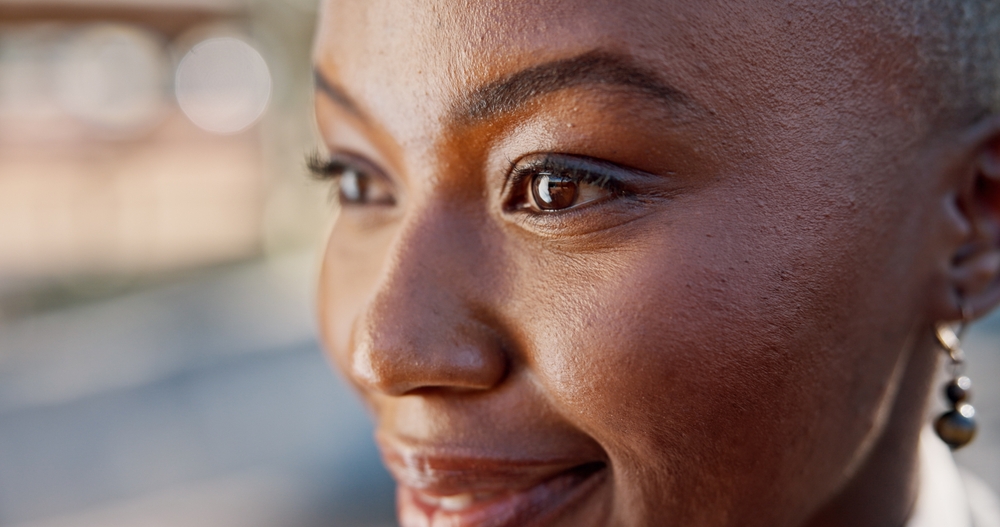 Black woman, face and eyes with thinking for vision, optometry or wellness with contact lenses for eyesight. Future, closeup and female person with optical solution, eyecare and ophthalmology space