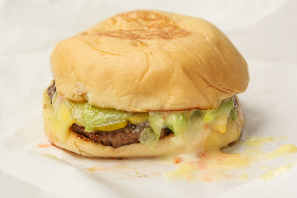 beef burger on white wrapping paper