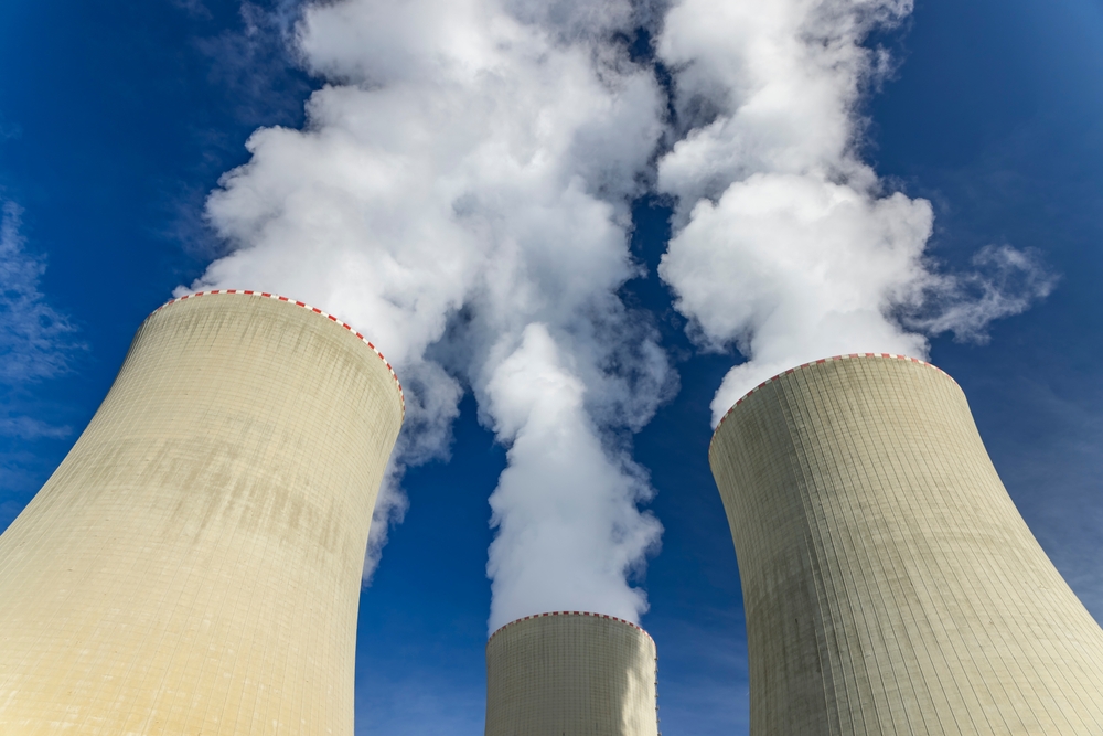 Cooling towers of Temelin Nuclear Power Station releasing steam against a blue sky, located in South Bohemia, Czechia