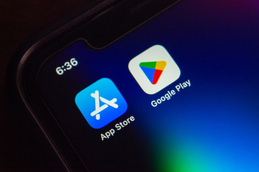 Mexico City, MEXICO - Sep 3 2025 : Close-up of a smartphone screen showing the App Store and Google Play app icons side by side on a dark background.