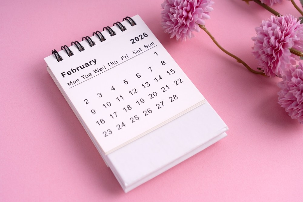 2026 February desk calendar with pink flowers on pastel background