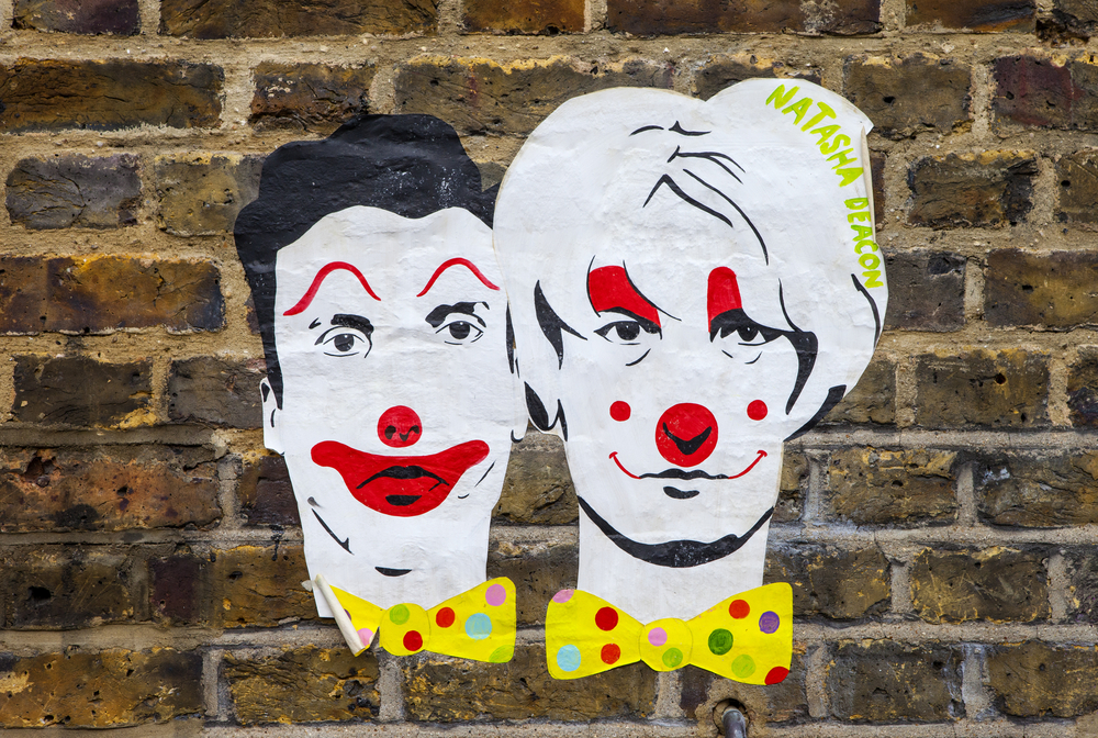 LONDON, UK - JANUARY 13TH 2016: A paste-up urban artwork by Natasha Deacon on a wall in East London, on 13th January 2016.  The paste-up depicts infamous Myra Hindley and Ian Brady as clowns.