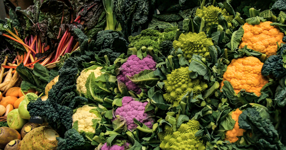 Panning display of different variety of winter vegetables at a food market