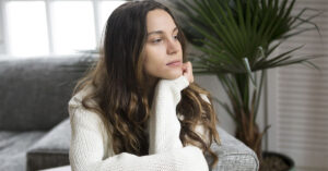 Why Some People Truly Enjoy Being Alone, According to Psychology thoughtful young person in a moment of quiet reflection