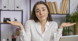 Philosophy Expert Asks: Why Do the Most Clueless People Keep Getting Promoted to the Top? woman shrugging shoulders
