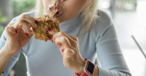 woman eating fried chicken