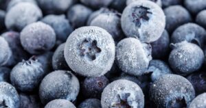 Scientists Reveal The Best Way To Eat Blueberries To Get The Most Antioxidants close up, frozen blueberries