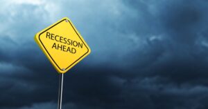 5 Red Flags of Recession Everyone Should Watch Out For in 2026 3D rendering, yellow warning sign reading "Recession ahead" with dark stormy clouds in background