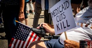 Medicaid Cuts: 446 Hospitals at Risk of Closure A protester in a wheelchair holds a “Medicaid Cuts Kill” sign during a peaceful rally at the Idaho State Capitol.