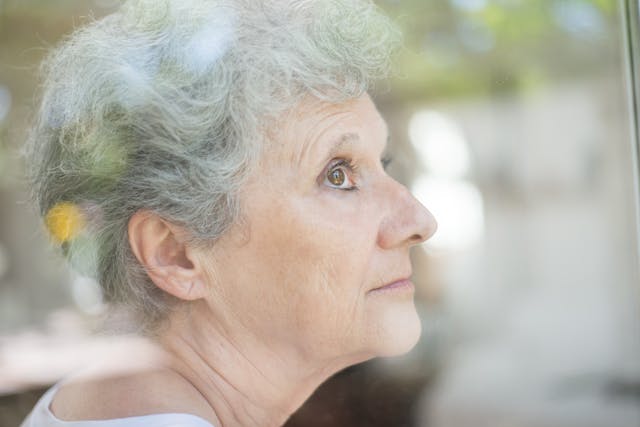 Elderly lady sitting in garden