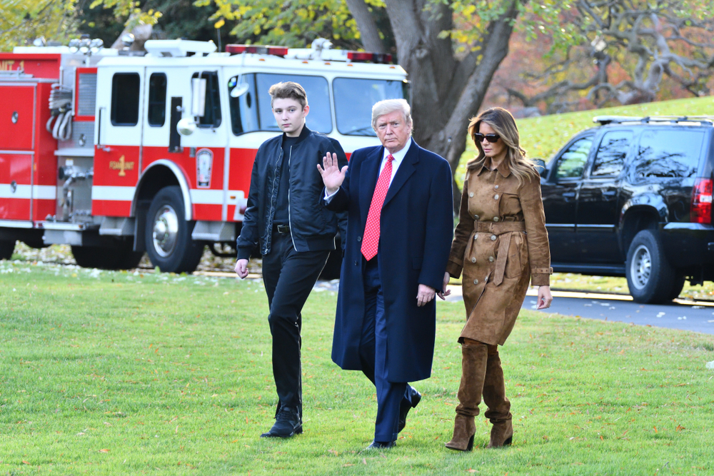 WASHINGTON, DC - NOVEMBER 26, 2019: President Donald Trump waves as he walks with First Lady Melania Trump and their son Barron to board Marine One on their way to Florida. White House South Lawn.