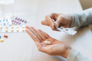 Nationwide Recall Issued for a Widely Used Anxiety Medication Healthcare,Harmony:,Close-up,Hands,Holding,Medication,And,Water,Glass,For