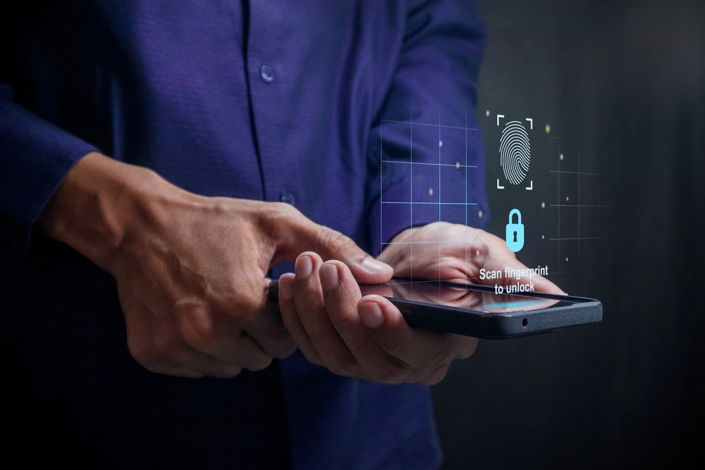 Man unlocks a smartphone by scanning fingerprint on virtual screen. Security access with biometric identification concept.