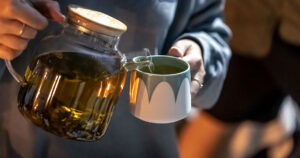 Valerian Root Reduces Anxiety and Improves Sleep in Clinical Trials, Health Review woman pouring valerian tea into a cup
