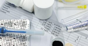 Taking Blood Thinners? These 10 Supplements Could Be a Problem Vet supplies like syringes and medicines on blood test reports, suggesting medical care theme.