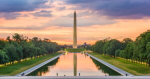 Black Fence Hides National Mall's Reflecting Pool Amid Paint Controversy Washington Monument on the Reflecting Pool in Washington, DC, USA at dawn.