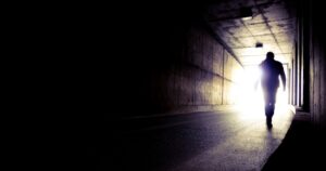 Scientist Who 'Died Three Times' Saw the Same Thing Every Time A man going to the end of a tunnel to the light. Silhouette of a man going to light in the end of a tunnel. Moving to the future