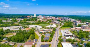 7 Real Towns Where You Can Retire on Social Security Alone in 2026 West Greenville, South Carolina, USA Skyline.