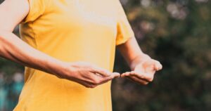 This 800-Year-Old Chinese Exercise May Help Lower Blood Pressure Like Some Medications woman doing qi gong outdoors