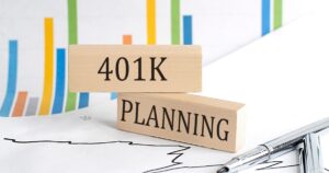 401 K PLANNING text on wooden block on chart background , business concept
