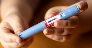close up of hands holding Ozempic injection pen
