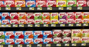 Jell-O Just Launched a Dye-Free, Lower-Sugar Line — Here's What's in It WALNUT CREEK - AUGUST 25: Boxes of Jell-O brand gelatin mix on shelf at grocery store. August 25, 2023, Walnut Creek, CA