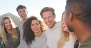 Are You the Fringe Friend? 3 Signs Psychologists Say to Watch For Group Of Young Friends Outdoors Talking And Laughing Together