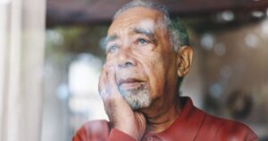 7 Things People in Their 80s Wish They'd Done Differently When Younger Depression, window and thinking with senior man in retirement home for loss, memories or nostalgia. Lonely, regret and sadness with unhappy person in apartment for anxiety, dementia or stress