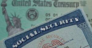 social security card in foreground emphasized with a blurred background of a united states treasury check
