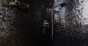 Why Men and Women Are Showering in the Dark for Better Sleep shower in a dark mosaic bathroom