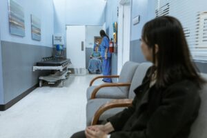 Medicaid Work Requirements Are Coming - Here's Who's Most at Risk A hospital scene showing patients and medical staff in a corridor, illustrating healthcare environments.