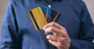 10 Places You Should Never Swipe Your Credit or Debit Card Person holding three credit cards, symbolizing finance, security, and e-commerce.