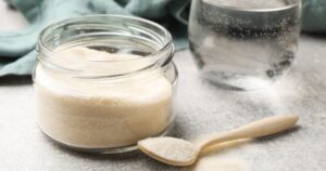Viral Gelatin ‘Ozempic’ Drink Sparks Buzz, but Nutrition Experts Urge Caution Powdered gelatin in a glass container beside wooden serving spoon and glass of water