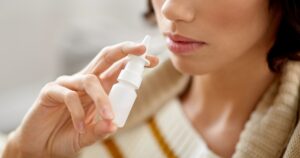 Amazon-Sold Nasal Spray Recalled Over 'Life-Threatening' Mold Contamination rhinitis, medicine and healthcare concept - close up of sick woman using nasal spray