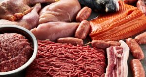 Doctor Lost 70 Lbs on an All-Meat Diet and Says 'We've All Been Misled' Carnivore diet or low carb diet background concept. Raw animal meat products beef, minced pork and sausages, chicken with dorado fish and salmon. High protein. Close up