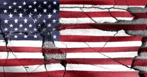 United States flag painted on cracked concrete symbolizing division and national crisis