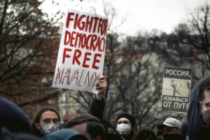 Most Americans Now Support Removing Trump — Here's What That Actually Takes Demonstrators in Prague holding signs advocating for political change and democracy.