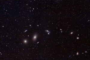 Captivating image of distant galaxies and star clusters in the vast universe. Perfect for astronomy enthusiasts.