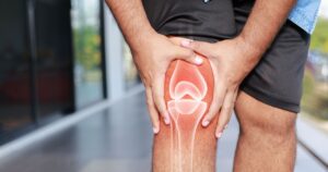 Stanford Scientists May Have Found a Way to Actually Reverse Arthritis Man holding his knee in pain. Arthritis concept